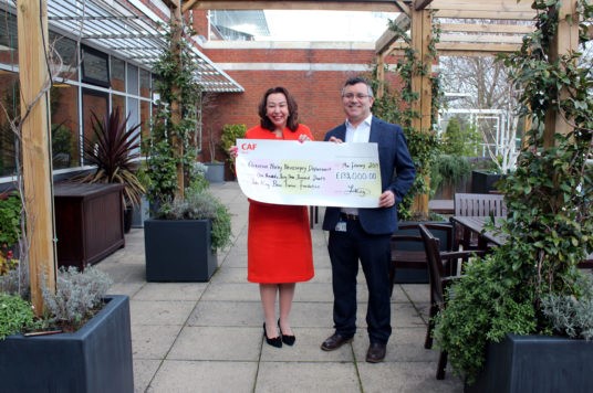 Laura King and Tim Jones hold a cheque for the Zeiss Microscope
